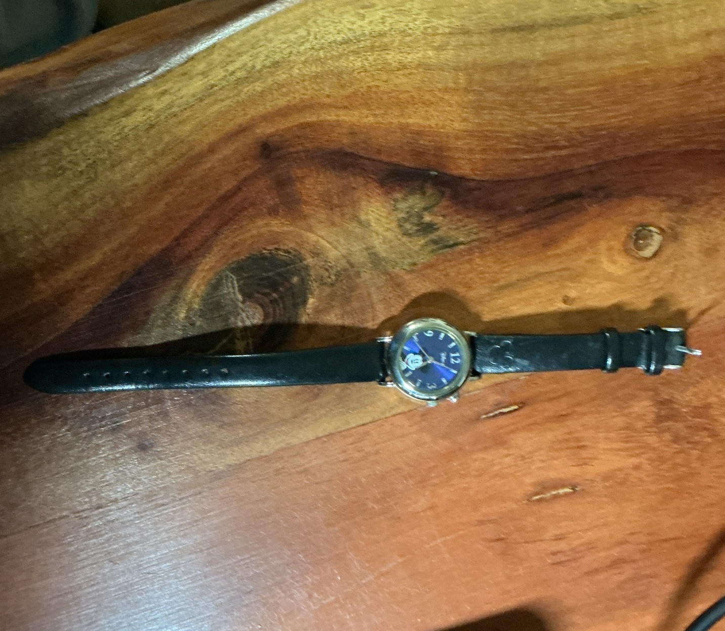 Disney Women’s Analog Wristwatch Blue Dial Gold Case Black Leather Strap