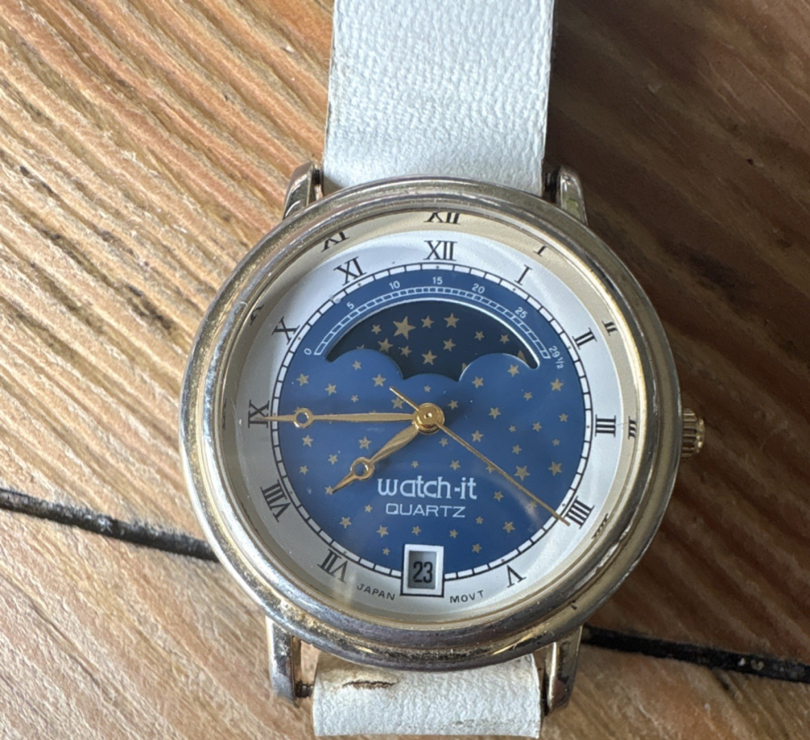 Nelsonic Watch-it Quartz Moon Phase Blue Star Dial Gold Case White Leather Strap