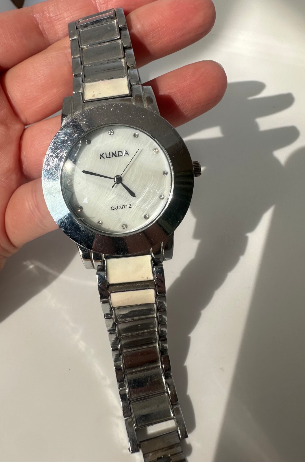Used Kunda quartz watch a silver-tone metal band and a white dial needs Battery
