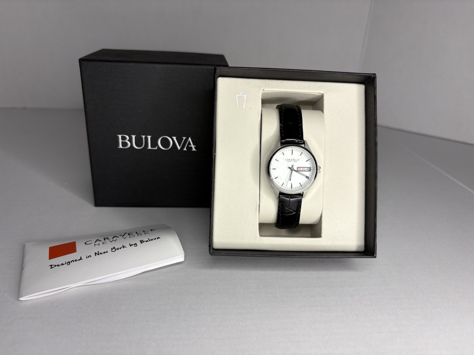 Caravelle New York Day/Date White Dial Black Leather Band Silver Watch w/ Box
