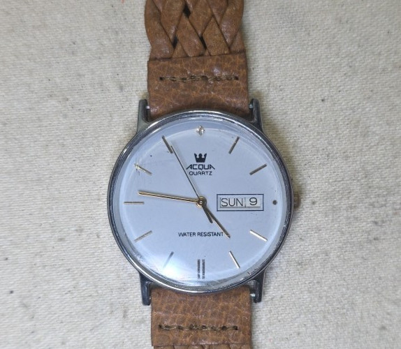 Acqua Quartz by Timex 1979 Light Blue/gray dial Silver case Brown Leather band