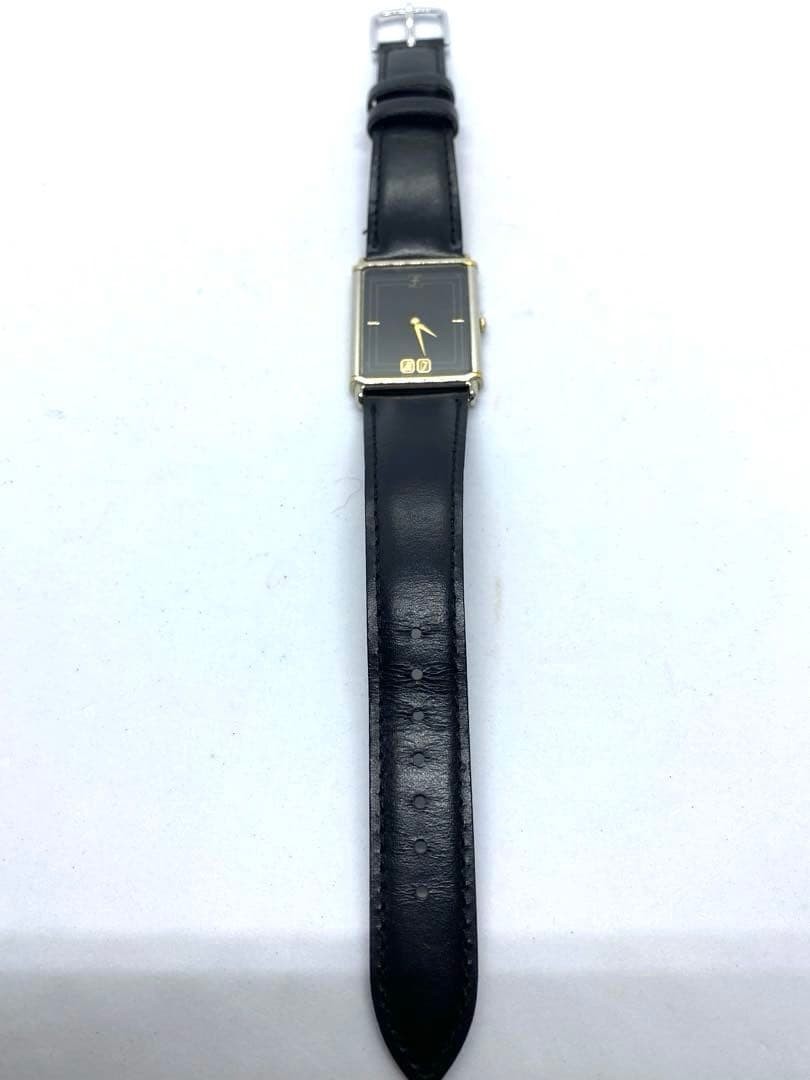 SEIKO rectangular quartz watch with black leather strap.