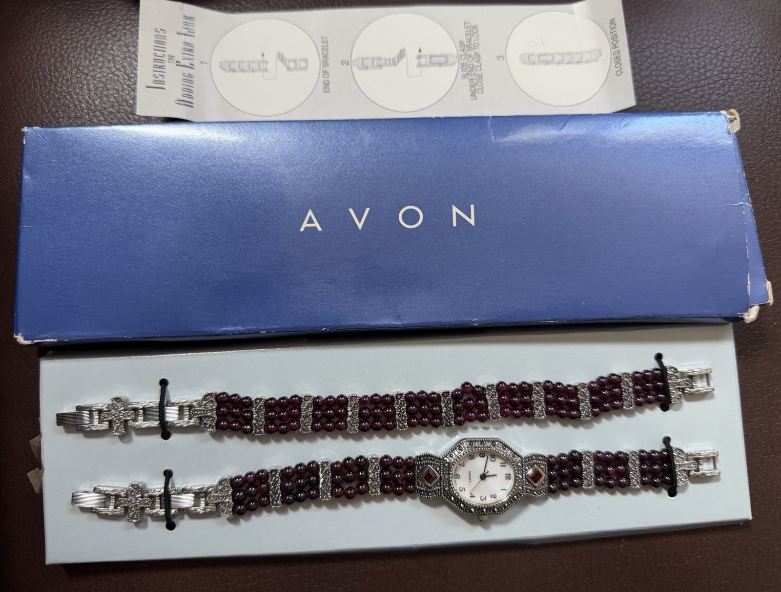 NIB AVON MARCASITE & GARNET QUARTZ WATCH AND BRACELET.