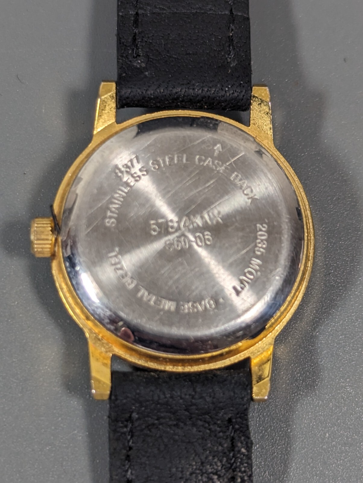 White Dial Gold Tone Round Case Black Leather Band Watch