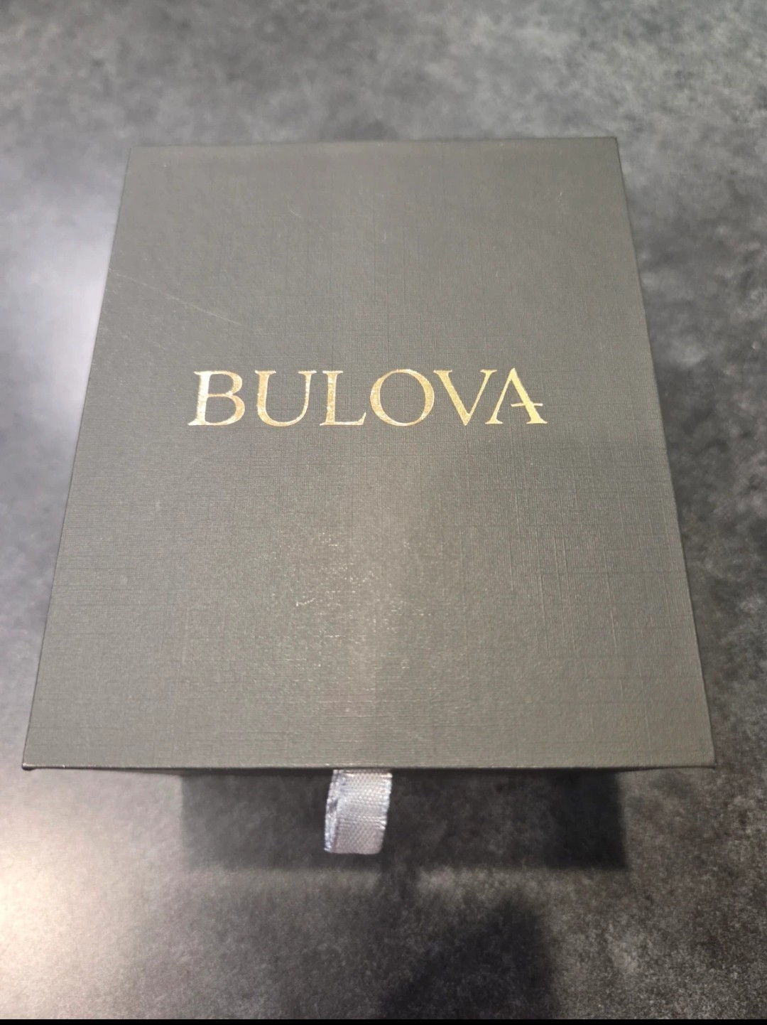 Bulova silver watch with rectangular face and diamond accents