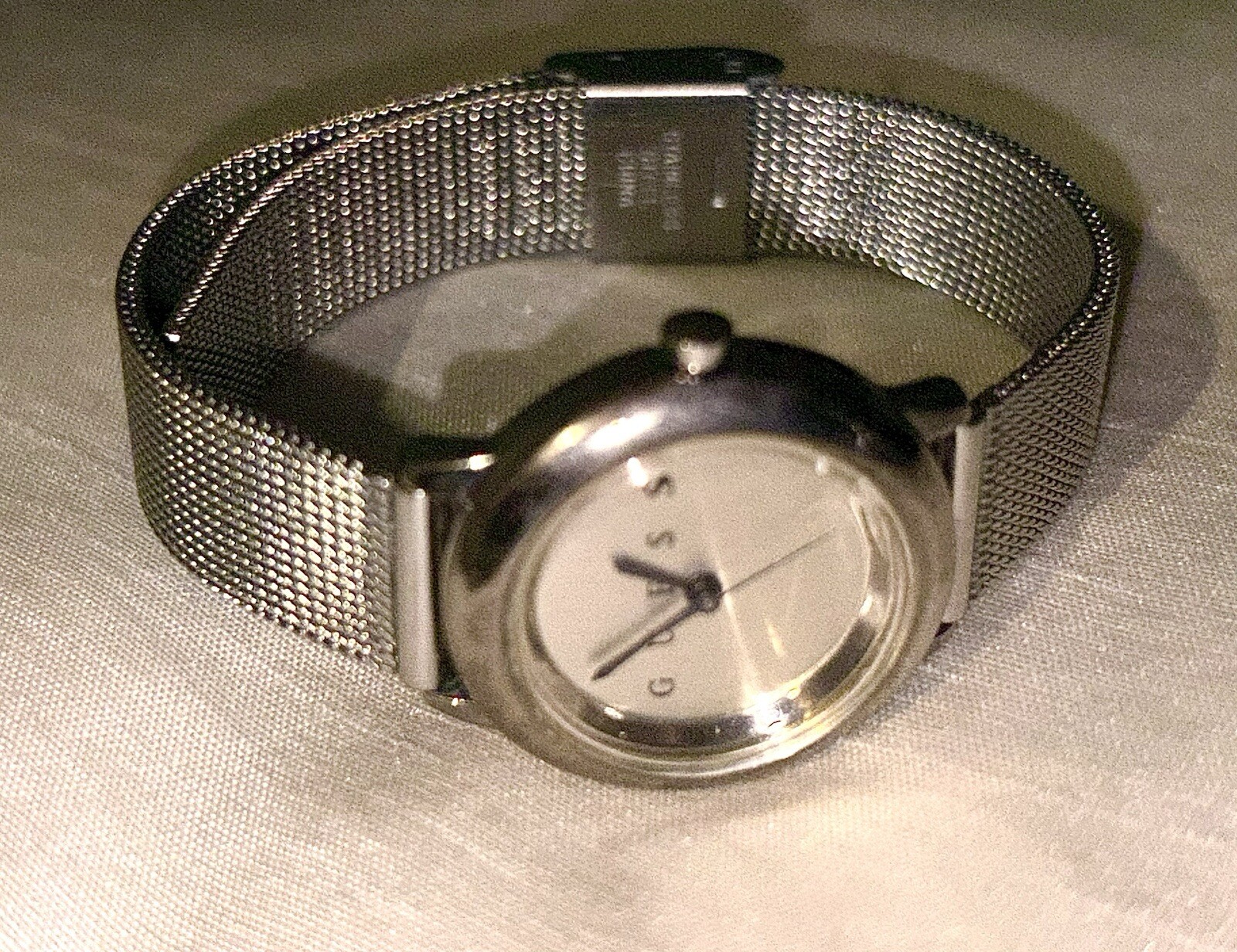1996 GUESS numberless face watch. silver w adjustable mesh band. new battery.