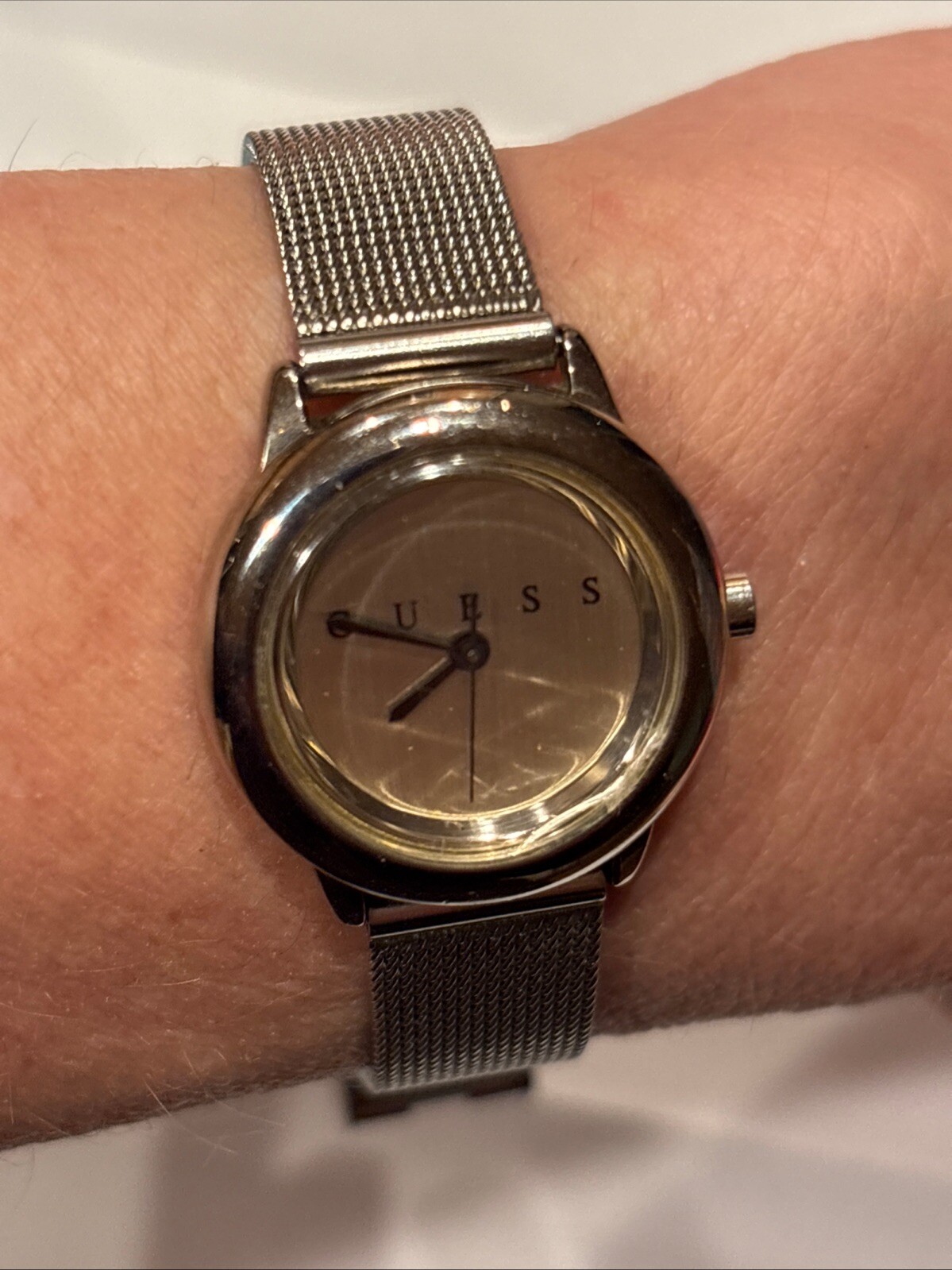 1996 GUESS numberless face watch. silver w adjustable mesh band. new battery.