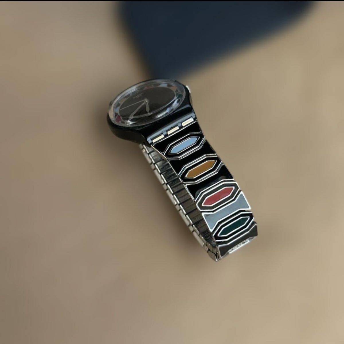 Swatch watch with black dial and multicolor bezel