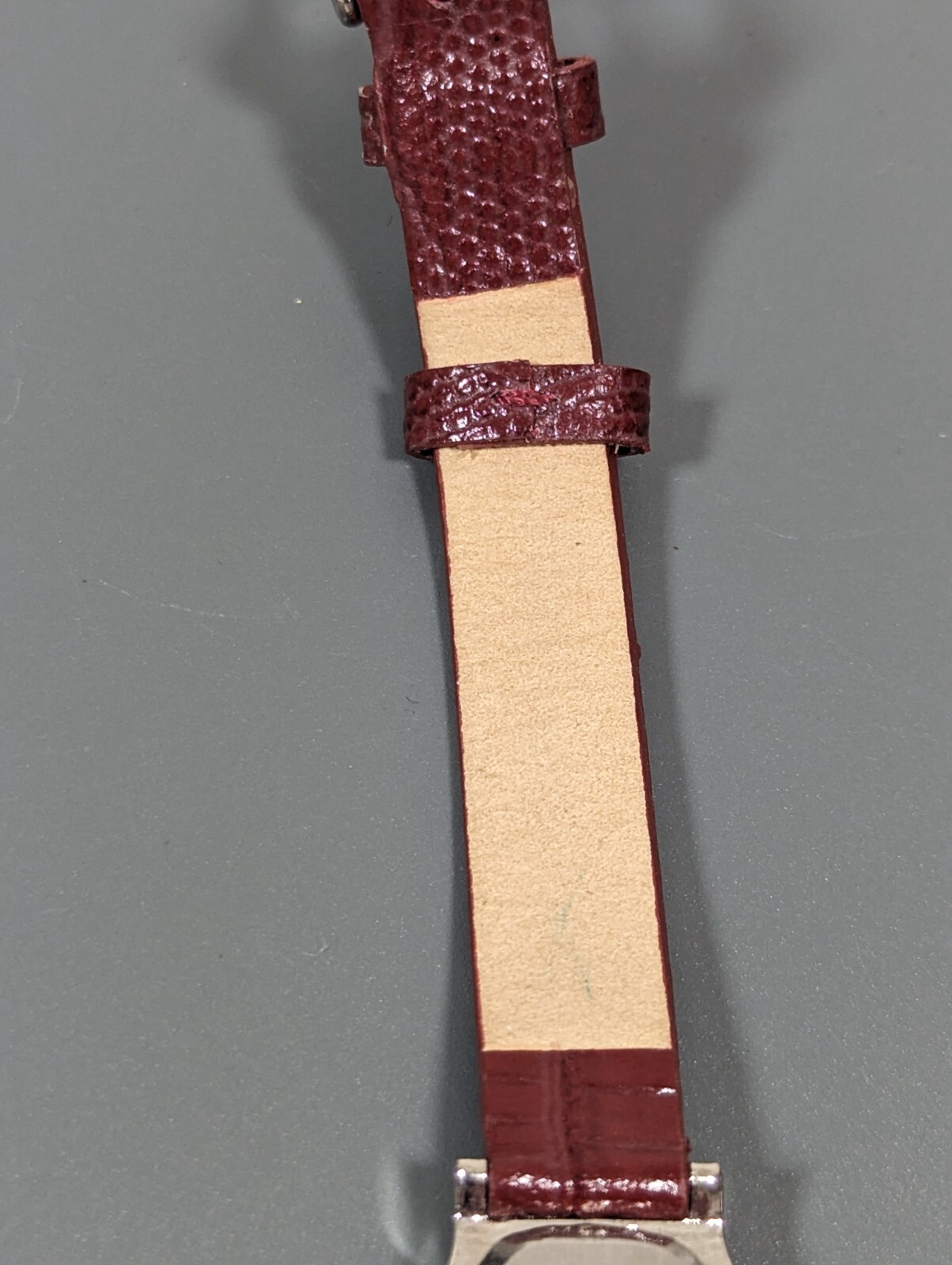 Black Dial Silver Tone Oval Case Red Leather Band Watch