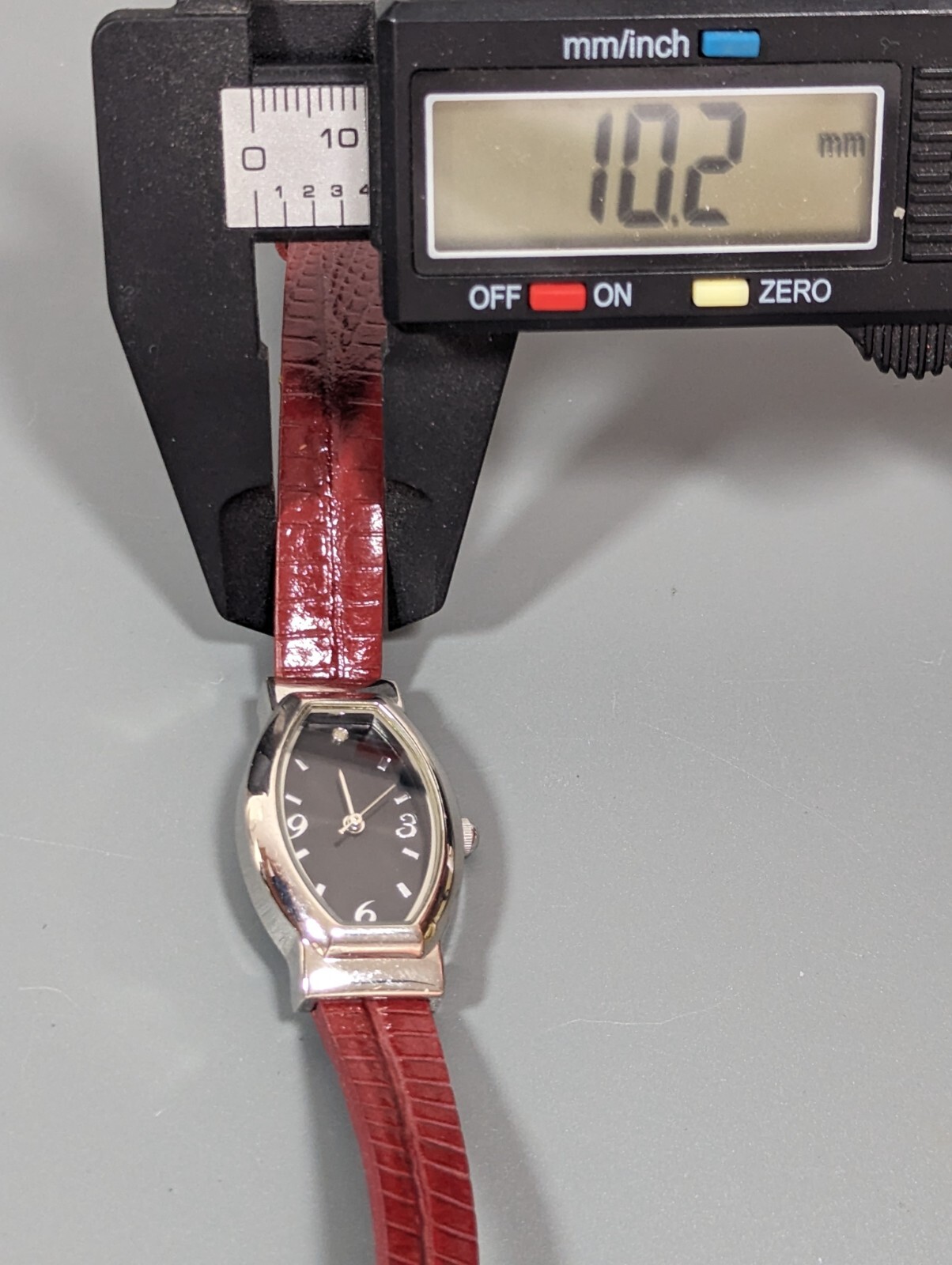 Black Dial Silver Tone Oval Case Red Leather Band Watch
