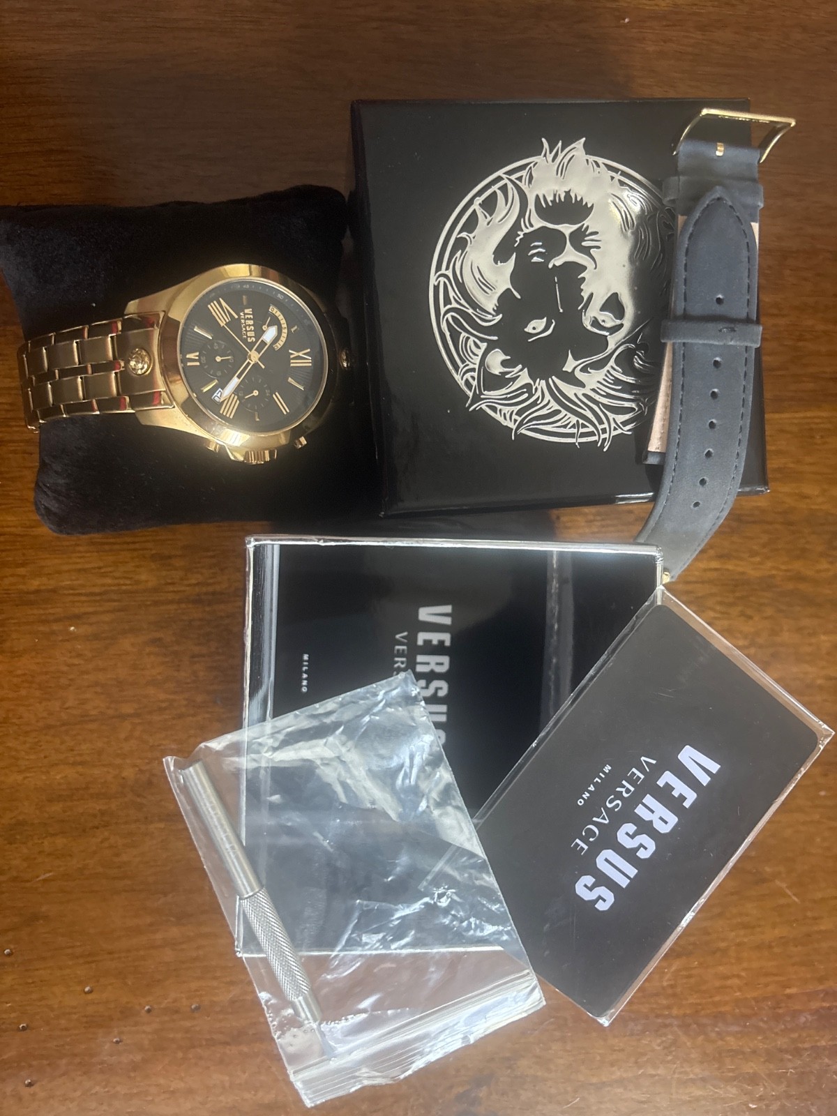 real Versace versus watch. 2 bands gold and leather lions on bands.