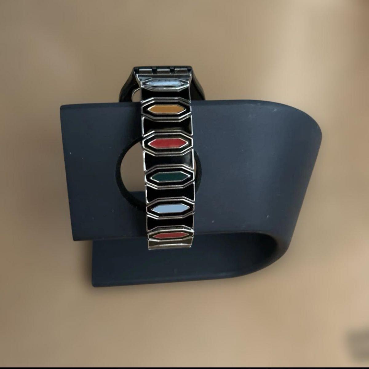 Swatch watch with black dial and multicolor bezel