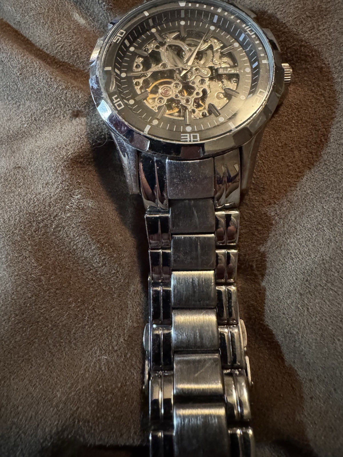 ELGIN”, “BASE METAL BEZEL”, “STAINLESS STEEL BACK”