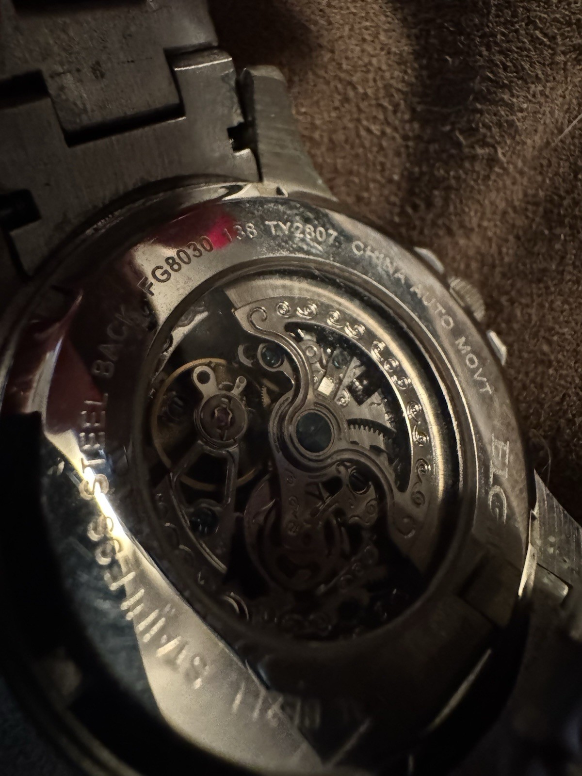 ELGIN”, “BASE METAL BEZEL”, “STAINLESS STEEL BACK”