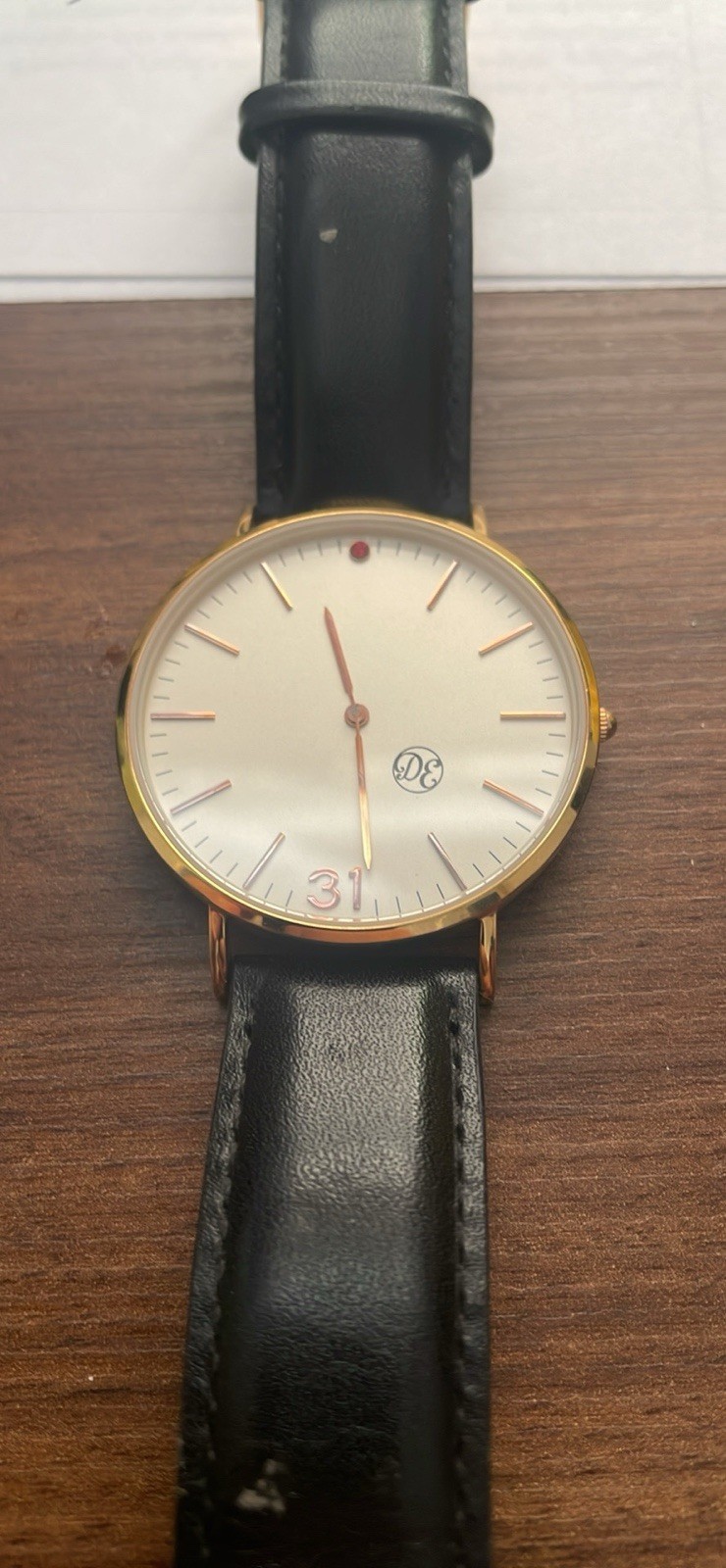 DE Gold Tone Analog Dress Watch White Dial Stick Index Date Black Leather Strap