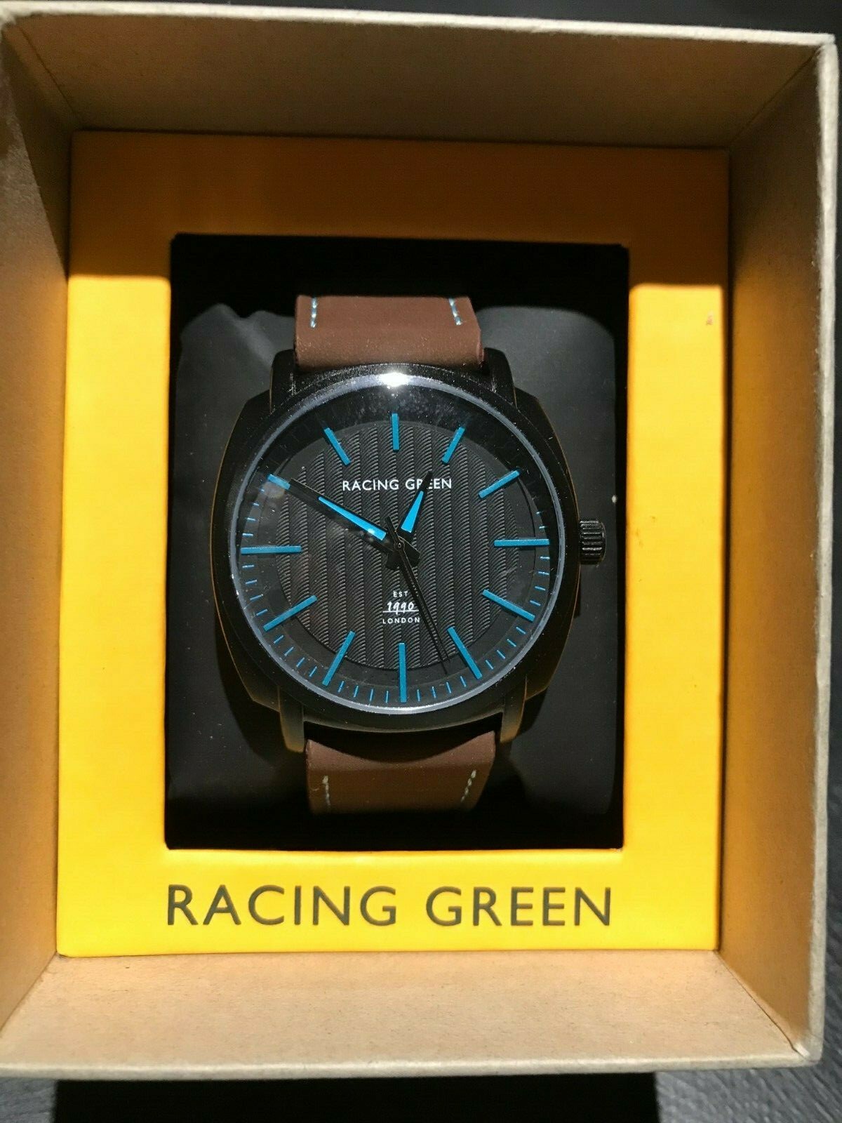 Racing Green Wrist Watch with Black Face, Brown Strap, Blue Hands & Markings
