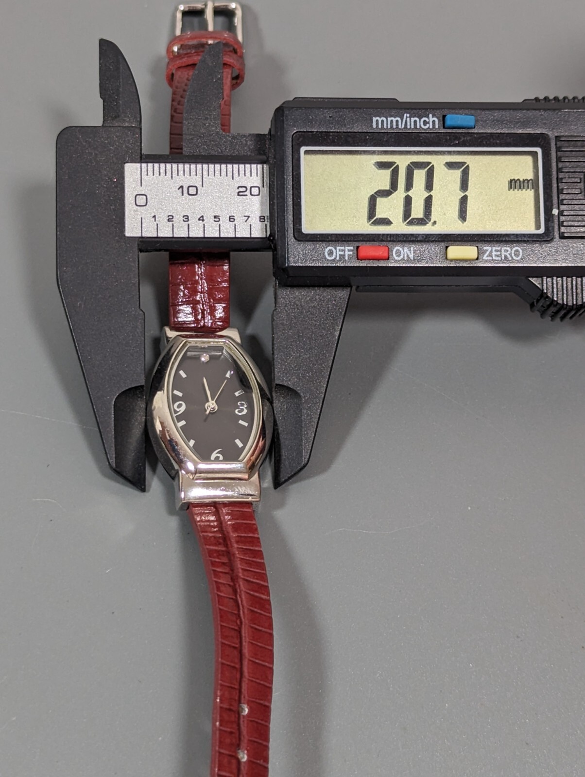 Black Dial Silver Tone Oval Case Red Leather Band Watch