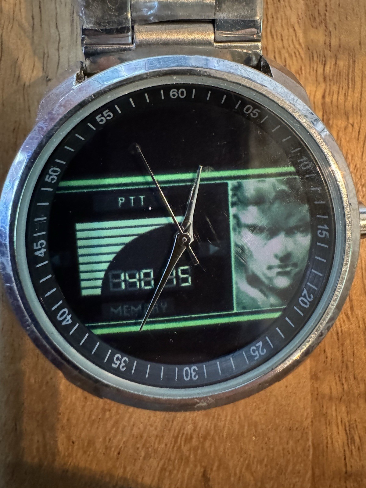 Analog wristwatch silver metal band brushed case black dial video game theme