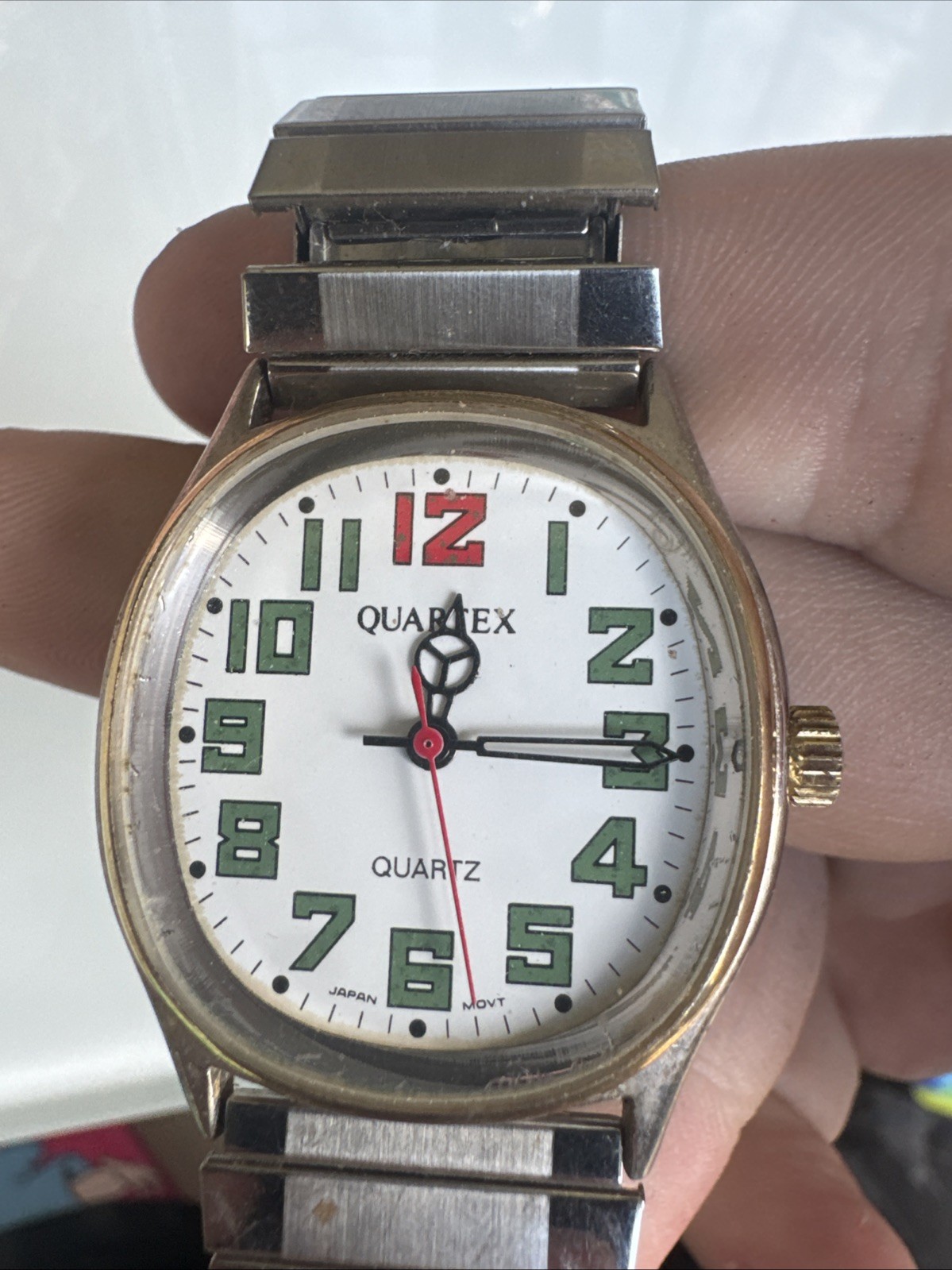 Quartex quartz watch silver with gold face red and green numbers