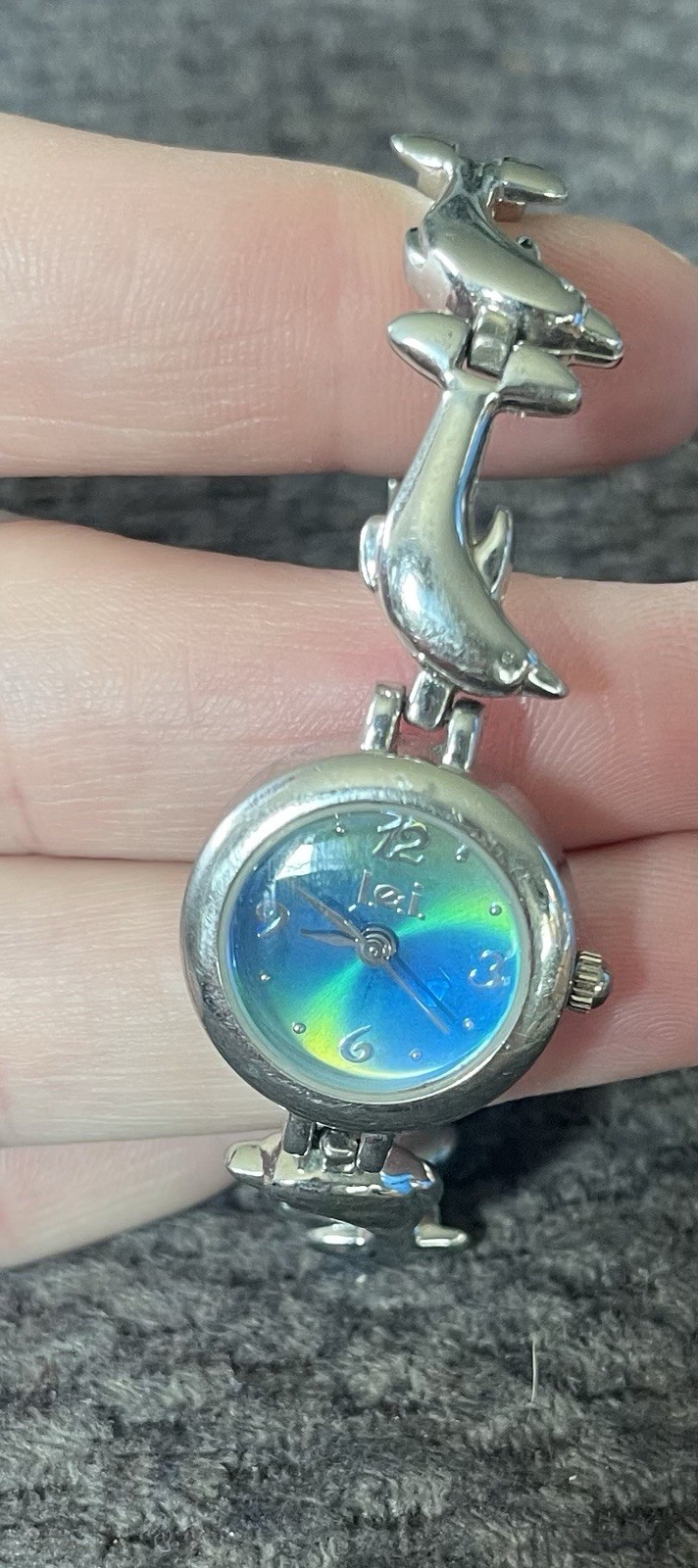 LEI Woman’s Watch Dolphin Band Silver Tone Blue-Yellow Iridescent Face