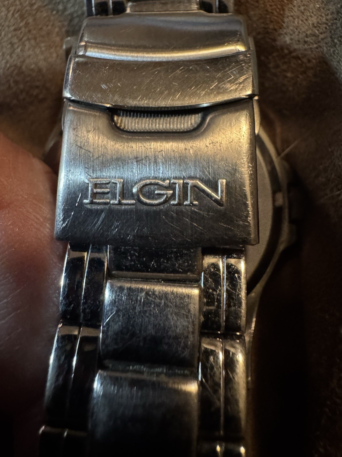 ELGIN”, “BASE METAL BEZEL”, “STAINLESS STEEL BACK”