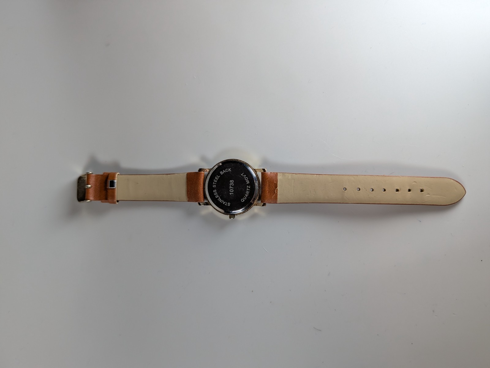 Elephant watch with flower pattern and gold outline and dot indexes brown band