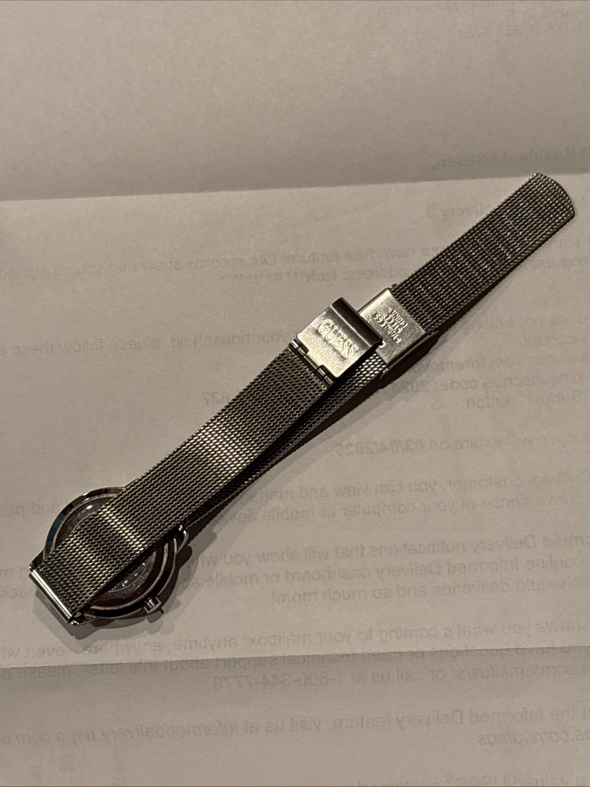 1996 GUESS numberless face watch. silver w adjustable mesh band. new battery.