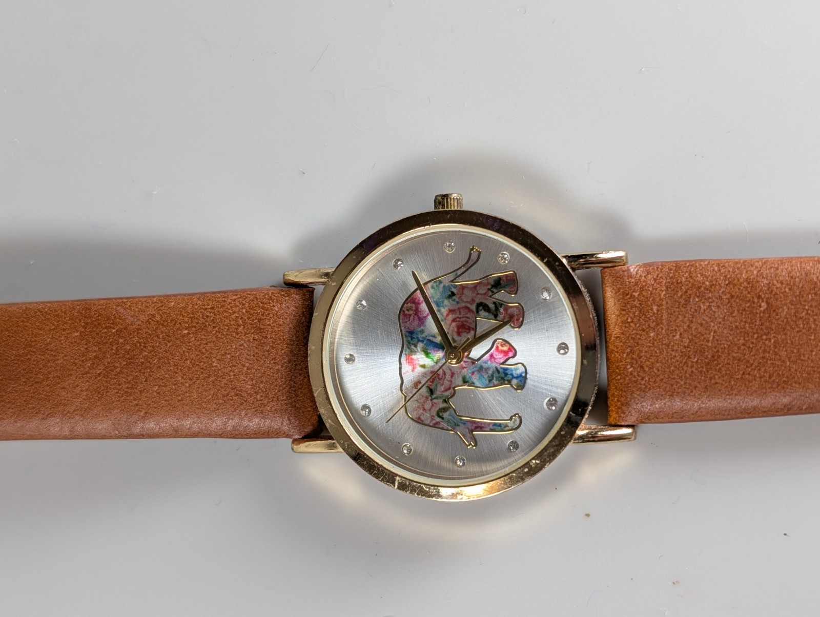 Elephant watch with flower pattern and gold outline and dot indexes brown band