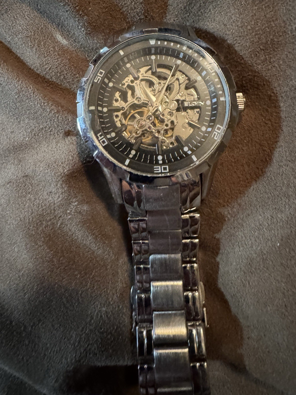 ELGIN”, “BASE METAL BEZEL”, “STAINLESS STEEL BACK”